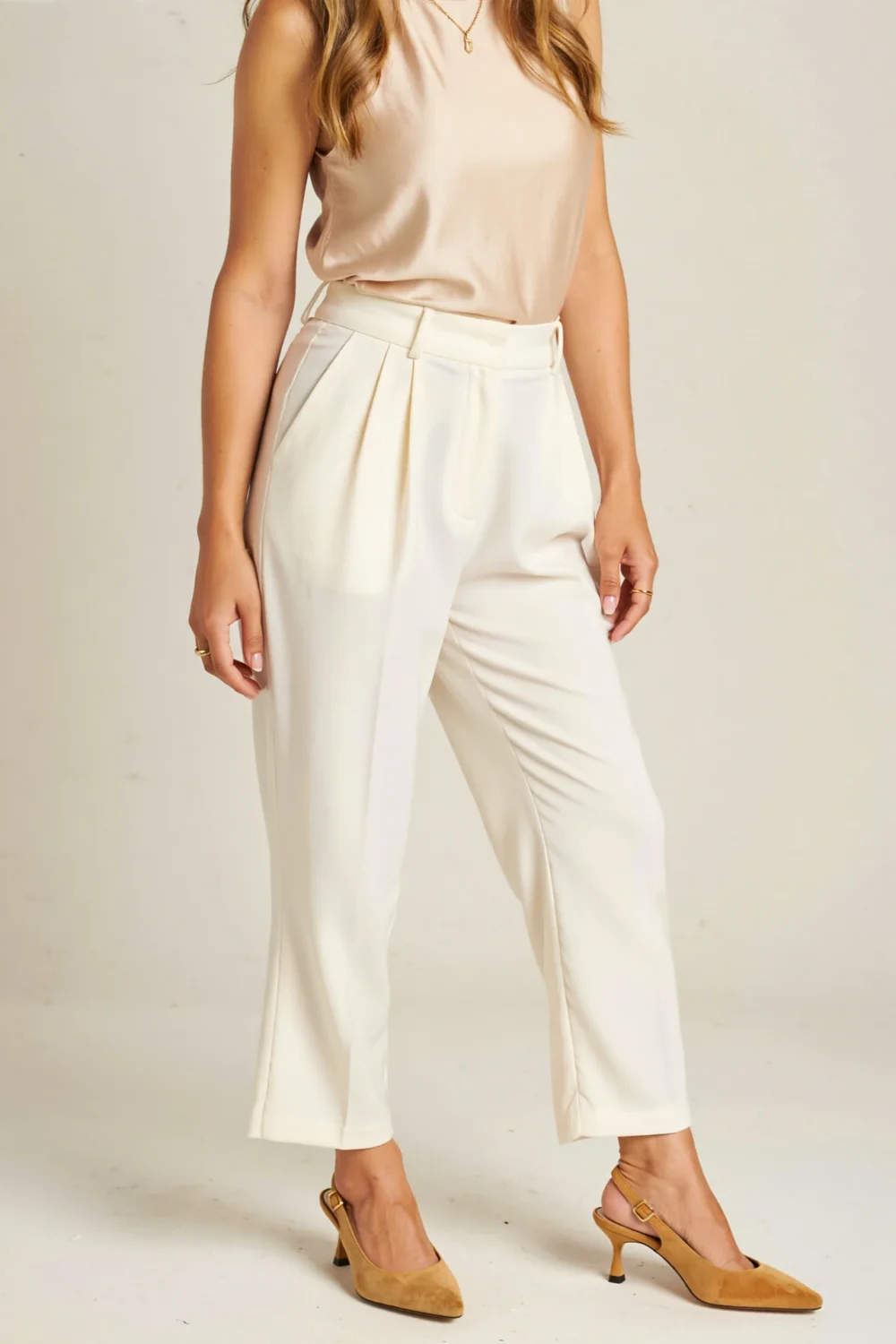 Beige slingback heels with white cropped pants and a cream top, creating a soft, elegant, leg-lengthening neutral outfit
