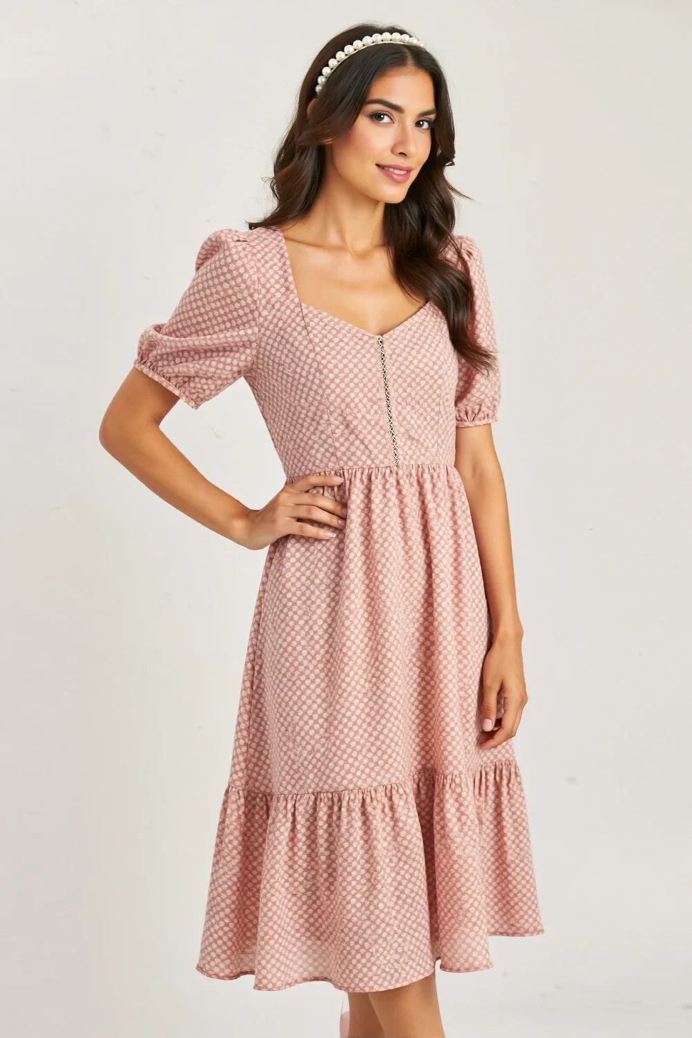 Blush print midi dress with modest neckline, puff sleeves, and pearl headband, creating a polished baptism celebration look
