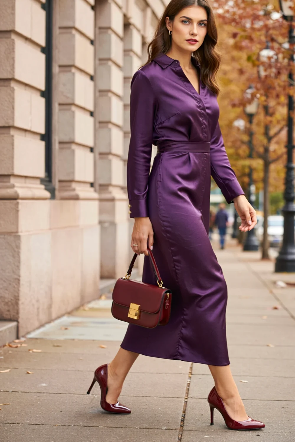 Woman in plum satin dress with burgundy heels and matching bag, creating a tonal autumn-ready look with rich purple depth