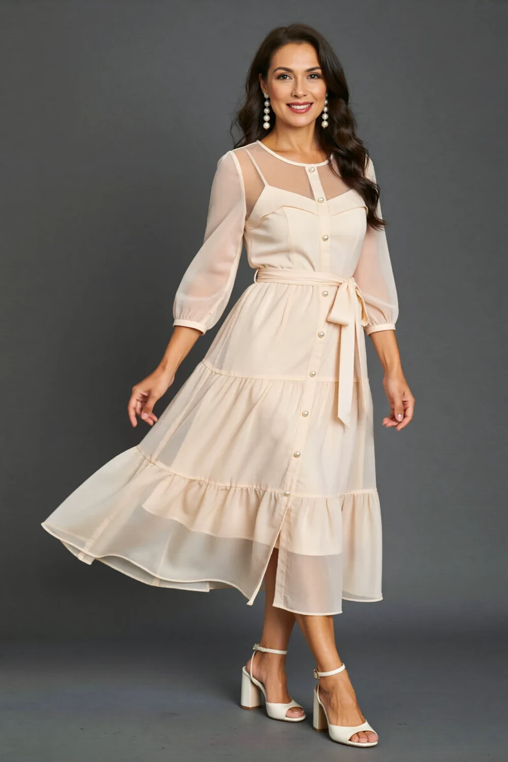 Elegant chiffon midi dress with soft sleeves, pearl buttons, and comfortable heels, creating a classic reunion-ready look
