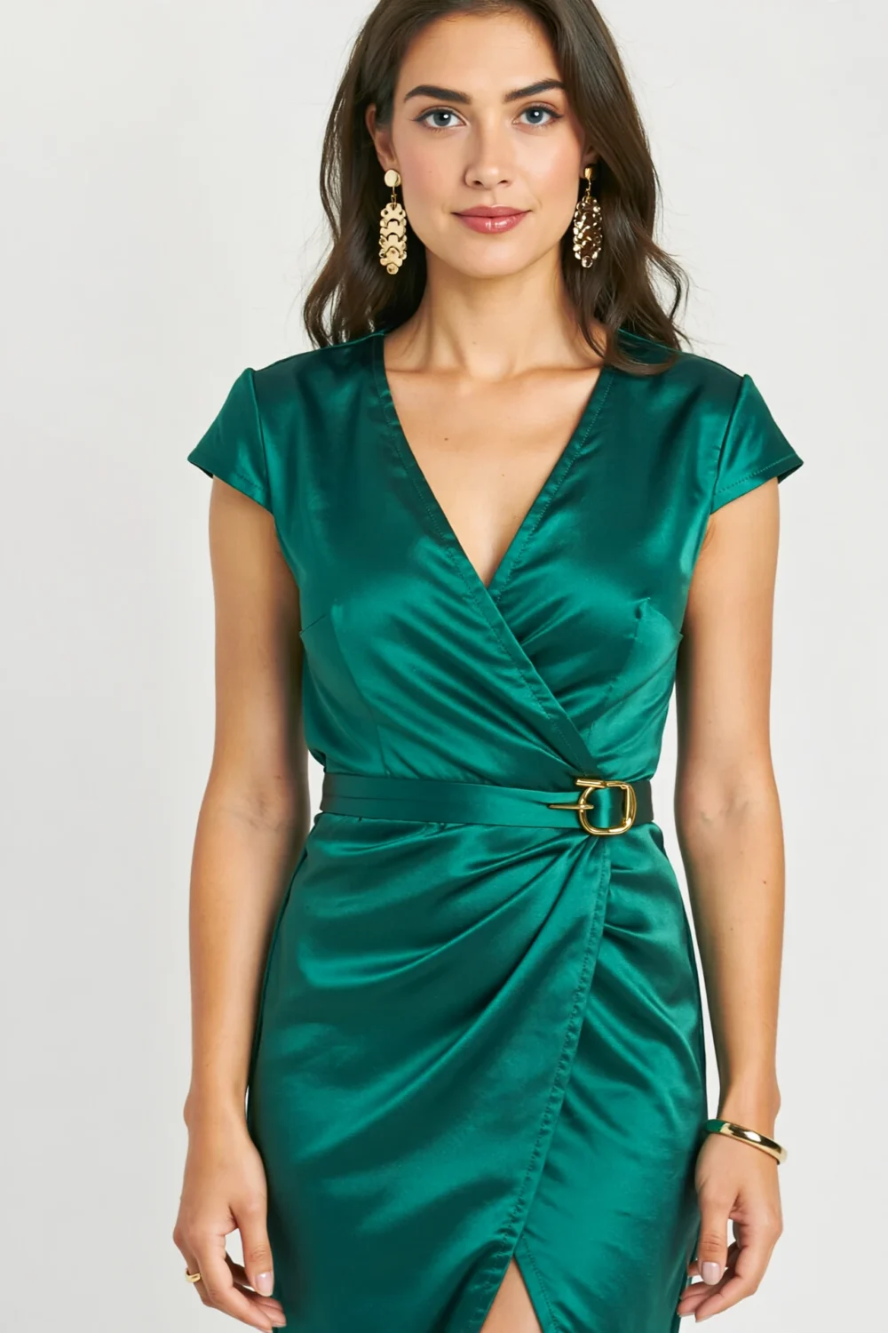 Emerald satin wrap midi dress with draped bodice, gold earrings, and belt, creating a polished festive look for receptions and events