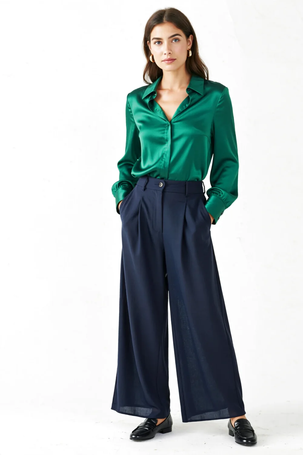 Emerald satin blouse with wide-leg navy trousers, gold hoops, and black loafers create a rich, elegant monochrome-inspired look.