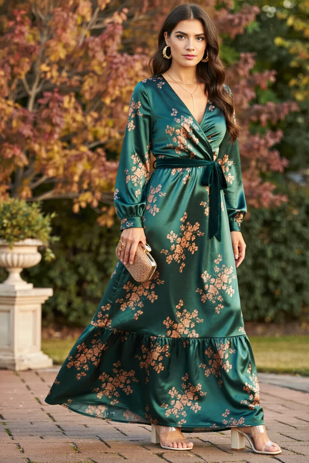 Forest-green satin tiered maxi dress with copper floral print, bishop sleeves and velvet ribbon belt, styled for a romantic fall wedding
