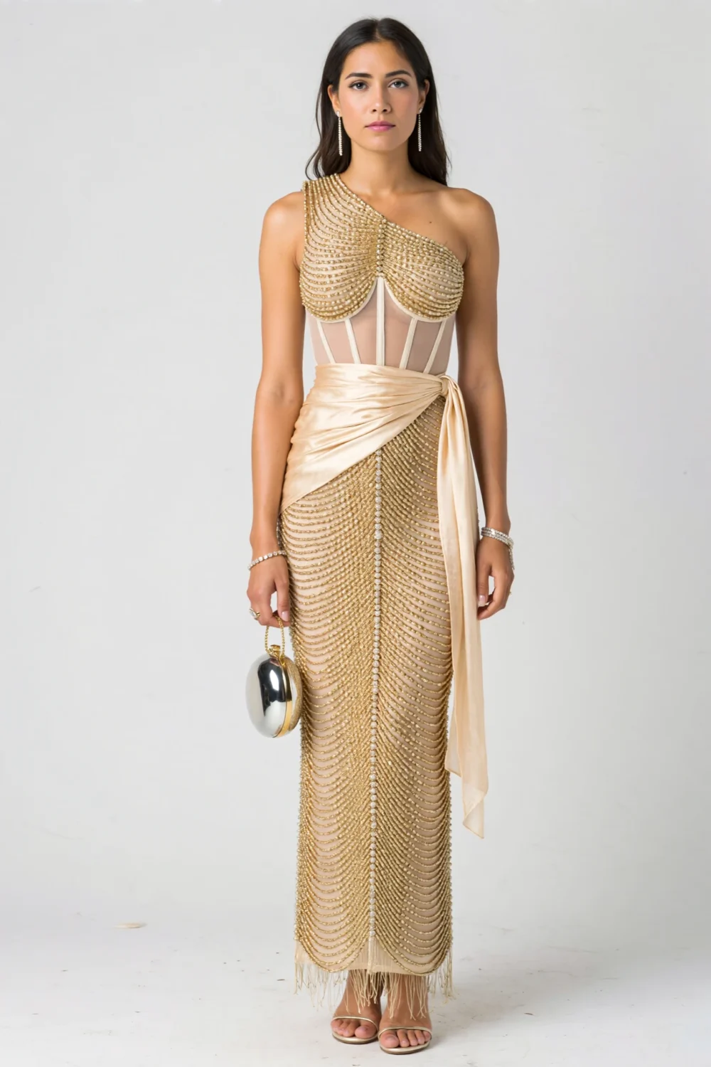 Model in bronze satin column gown with champagne crystal beading, sheer corset bodice, draped sash, and polished formal elegance