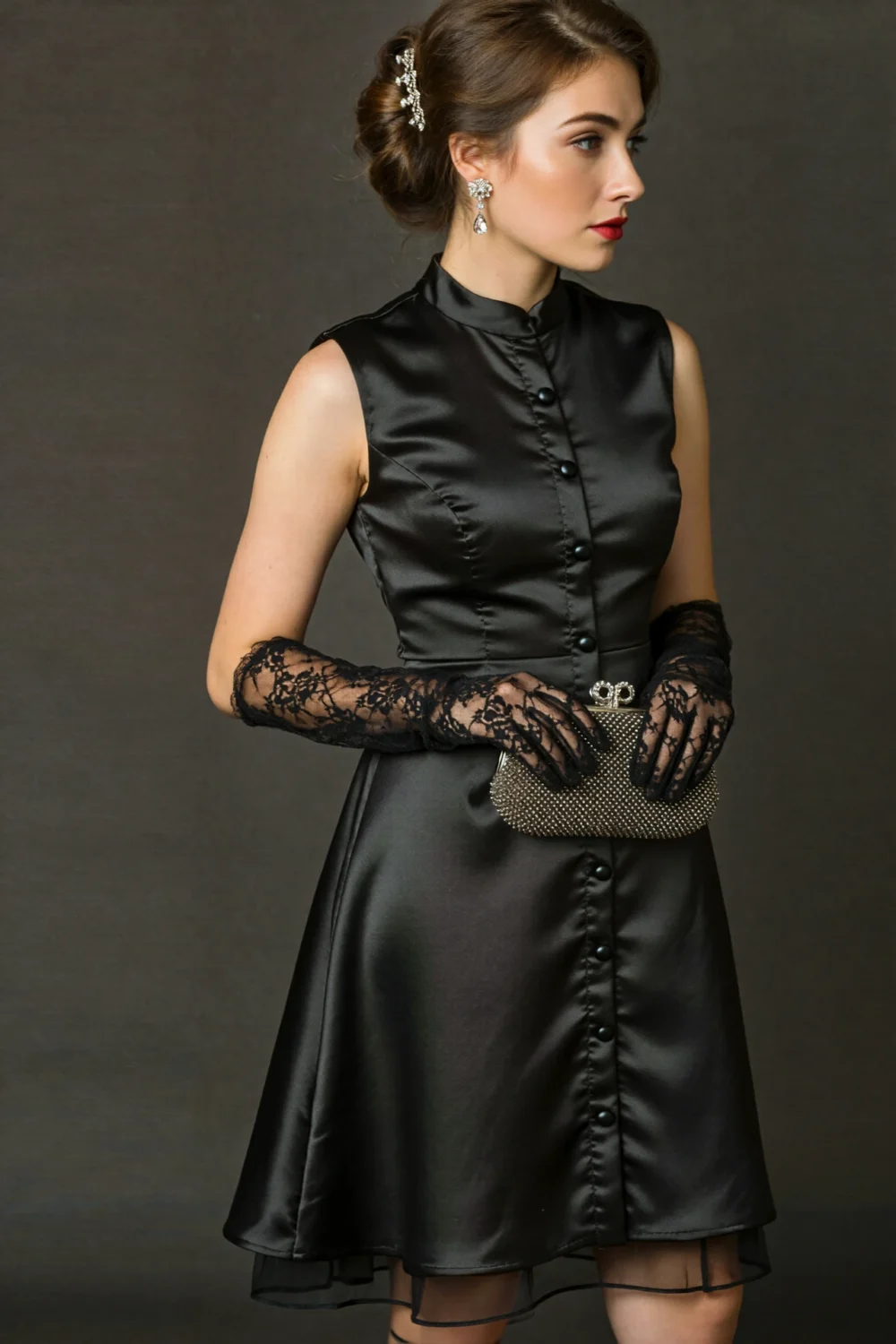 Black high-neck satin midi dress with lace gloves and beaded clutch, styled in an elegant vintage look for a Halloween wedding