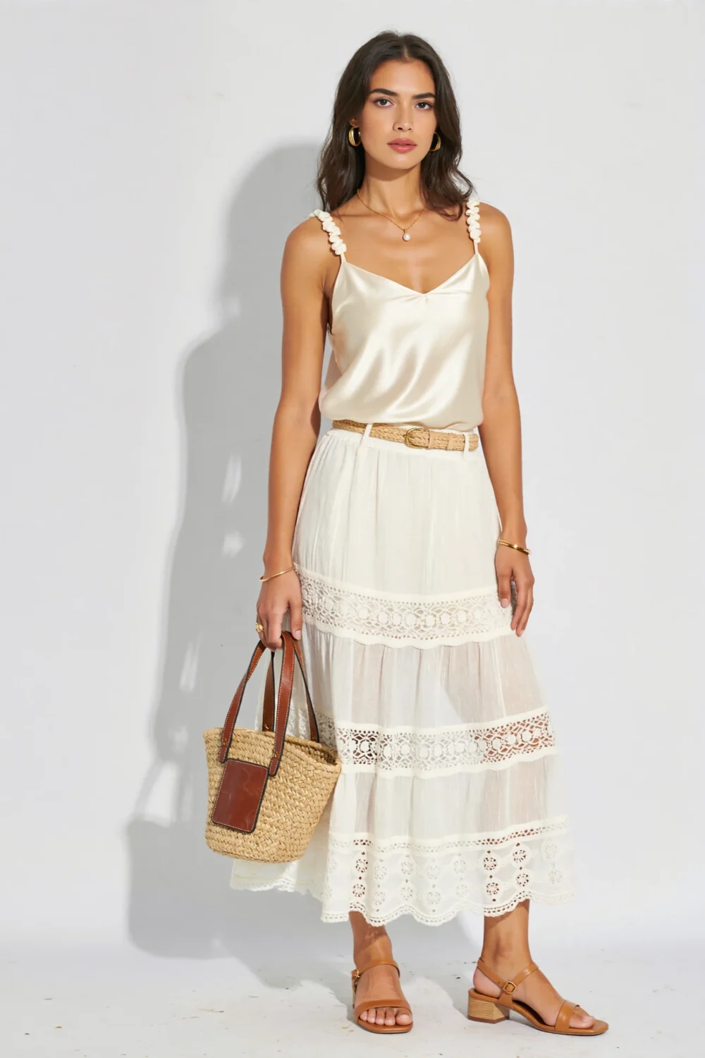 Ivory satin cami with tiered lace maxi skirt, raffia belt and bucket bag, styled with tan sandals for a soft summer look