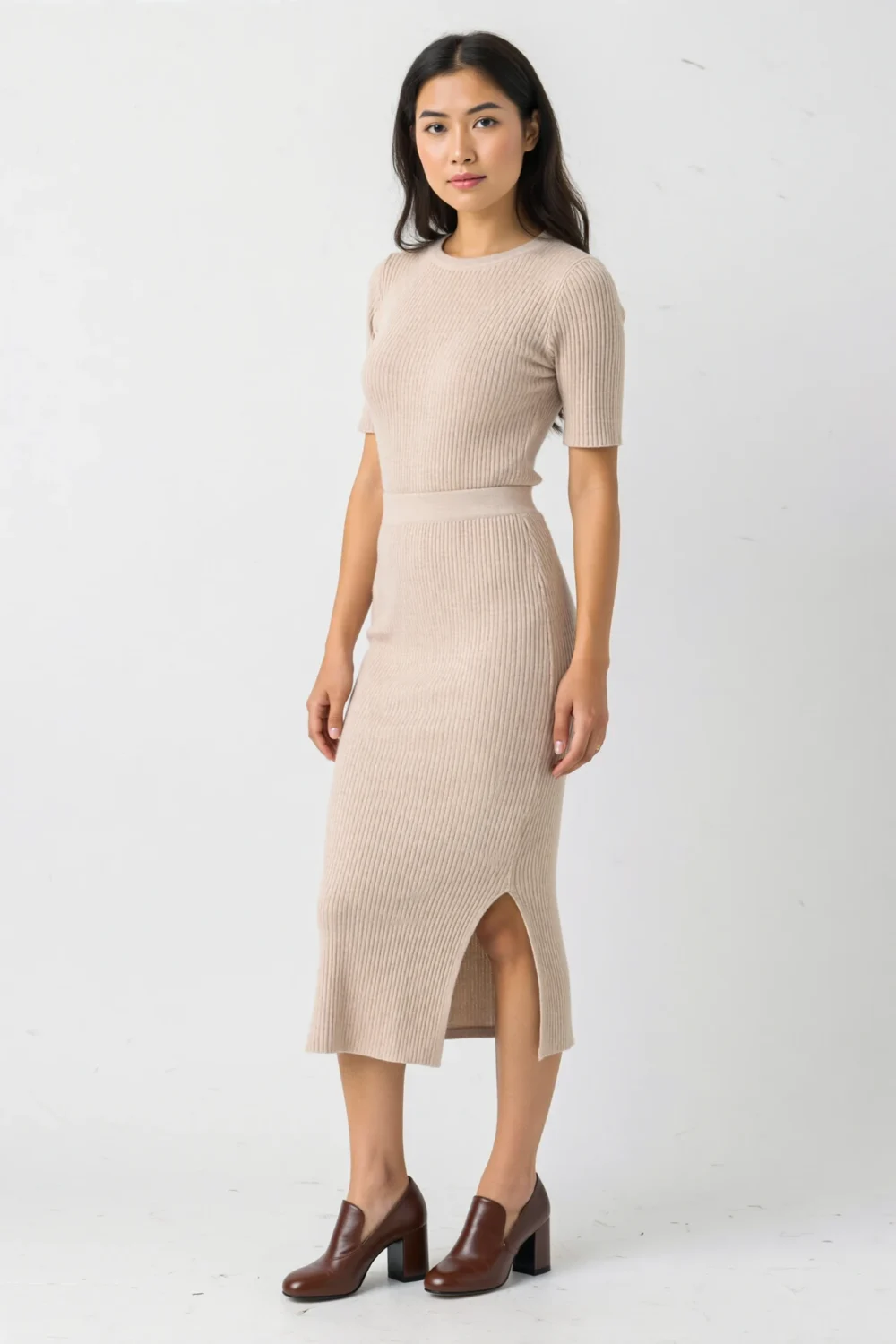 Beige ribbed knit midi set with fitted top and skirt, paired with brown block heels for a polished, comfortable look.