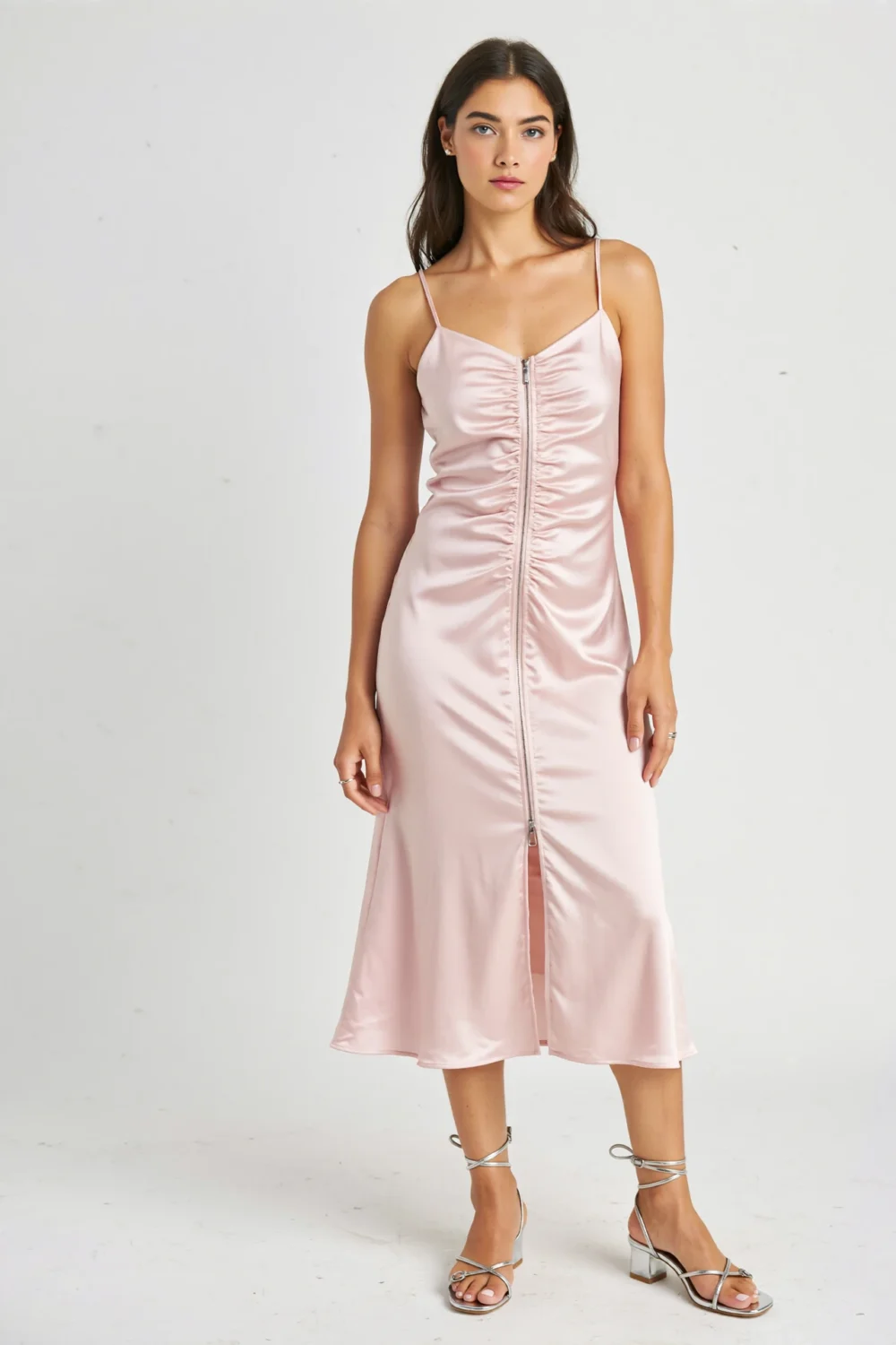 Model in a light pink satin dress with silver strappy sandals, illustrating a soft, cohesive outfit for daytime or evening styling