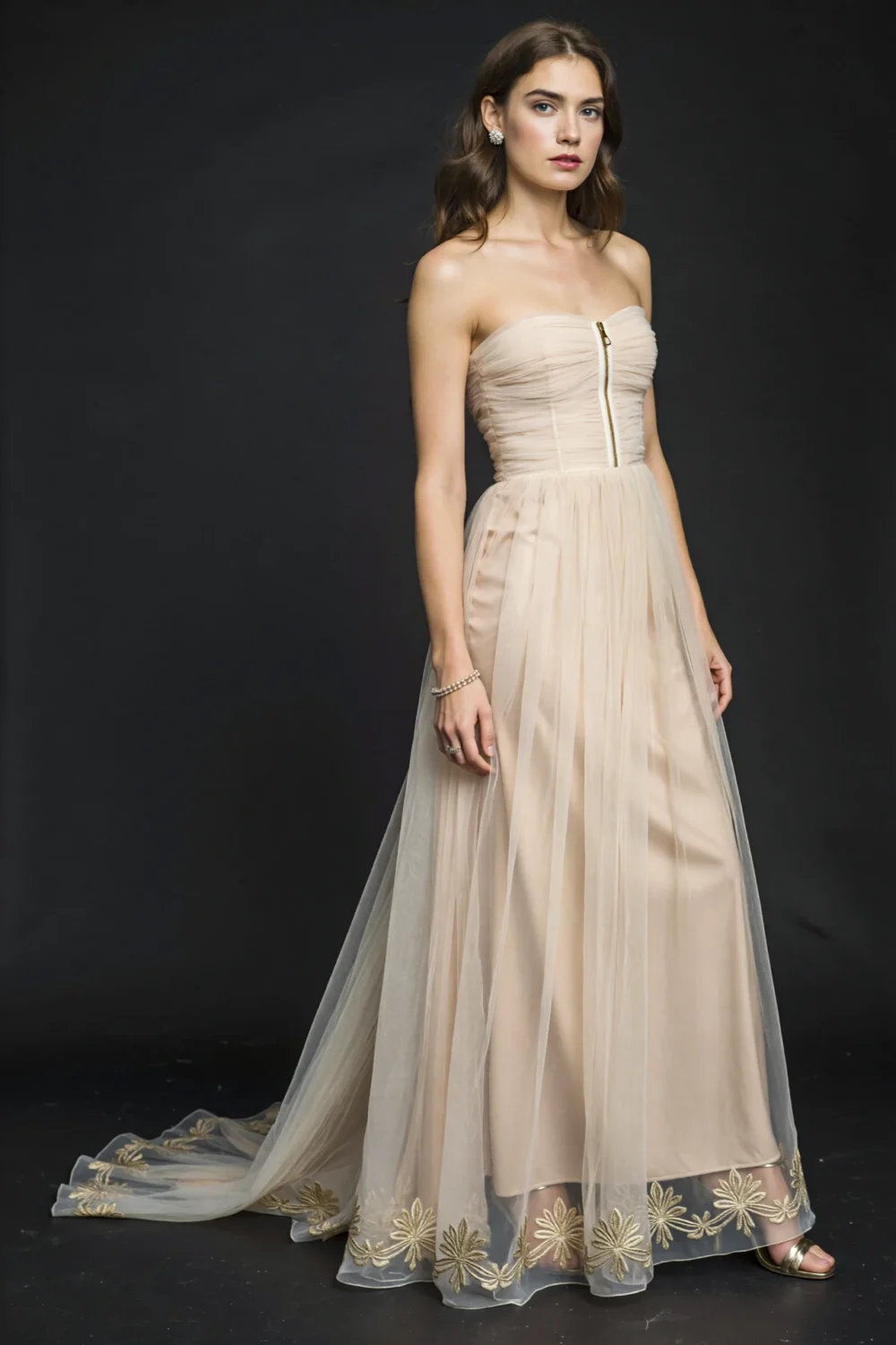 Lightweight floor-length chiffon gown with layered pleats, sheer overlay, and embroidered hem, styled for elegant formal reception wear