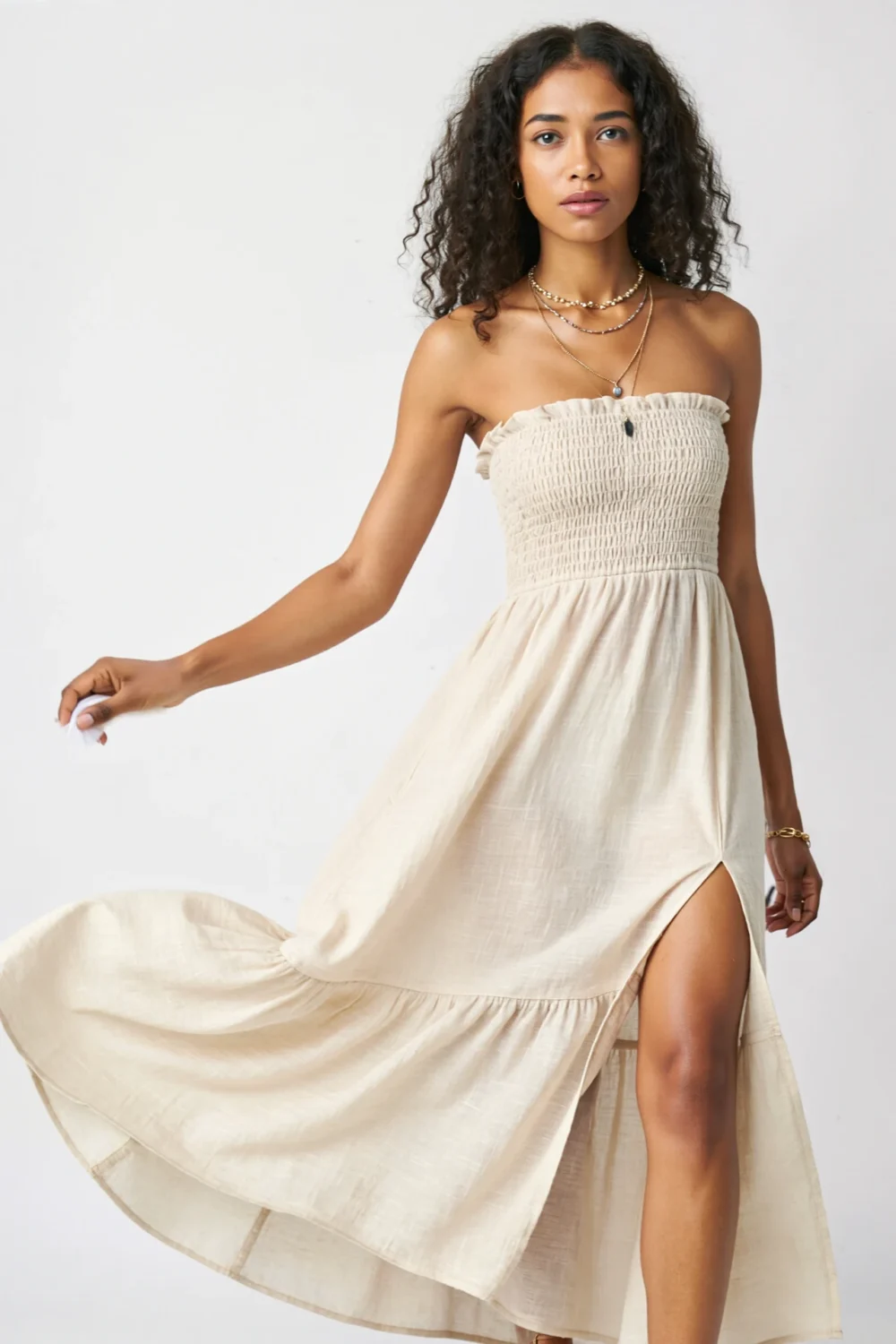 Flowy strapless maxi dress with deep side slit and layered necklaces, shown mid-sway for an easy, breezy festival-ready look