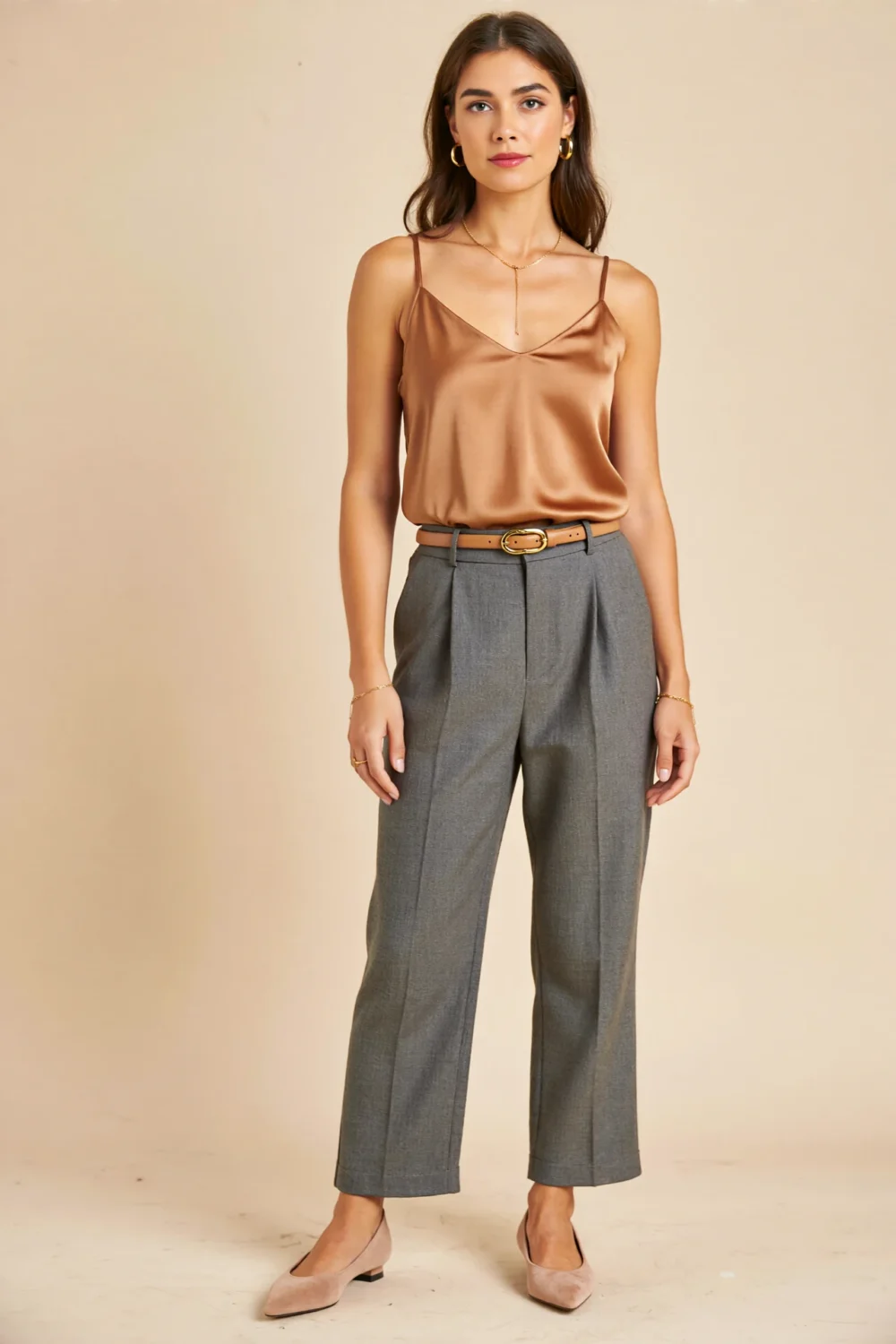 Mid-grey wool trousers with camel silk tank and thin tan belt, styled with nude suede pointed pumps for a polished, minimal luxe look