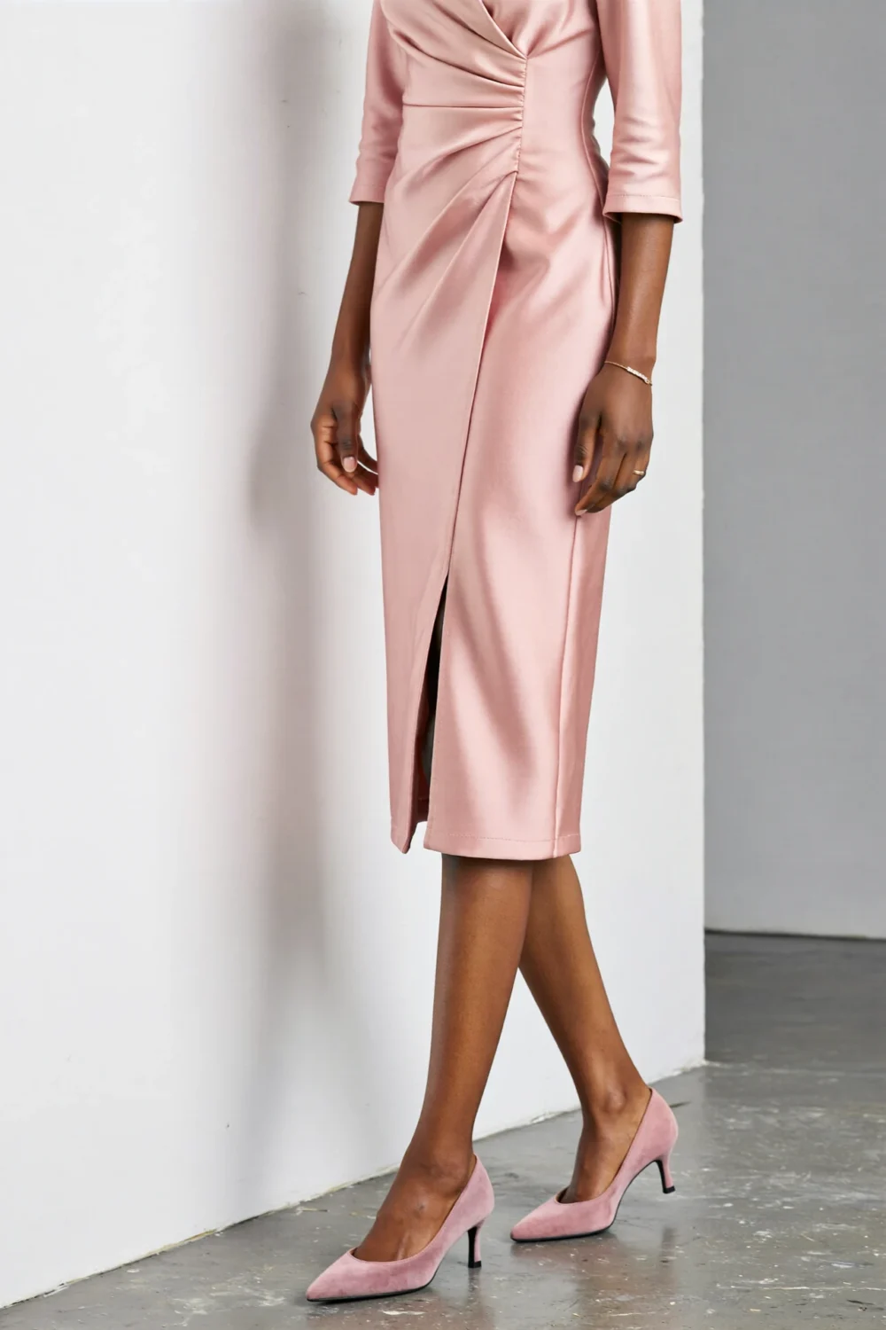 Tailored pink midi dress with defined waist and pointed-toe pumps, creating a sleek professional silhouette for polished days