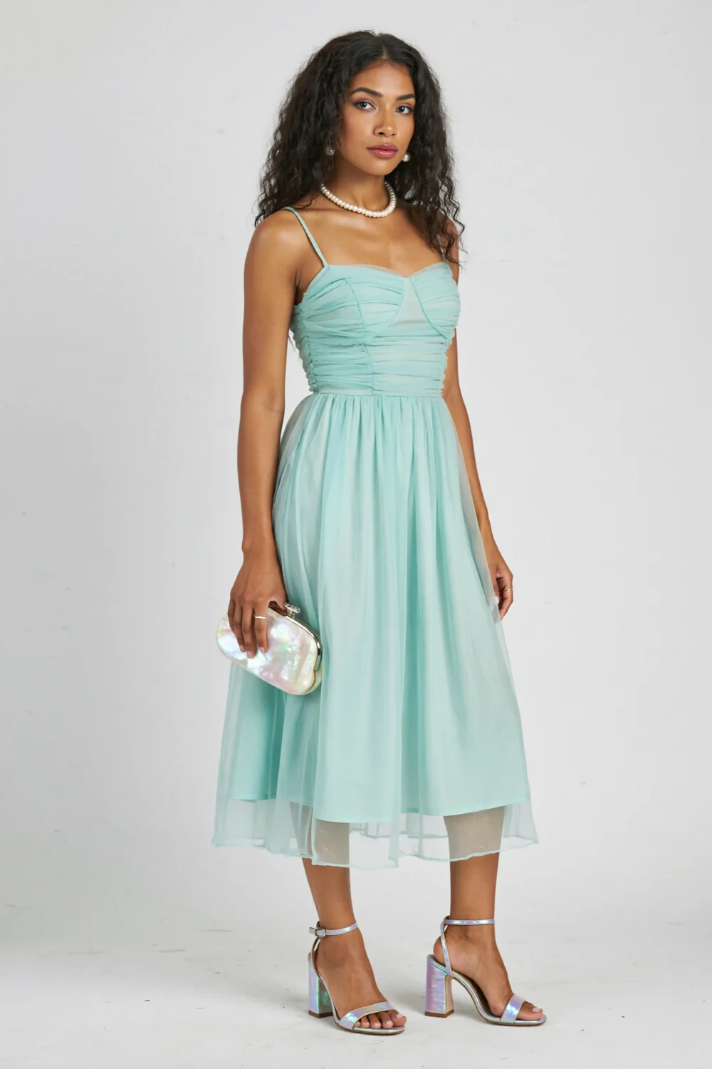 Mint green midi dress styled with pearly iridescent block-heel sandals, a dreamy couture look with subtle pastel shimmer and pearls