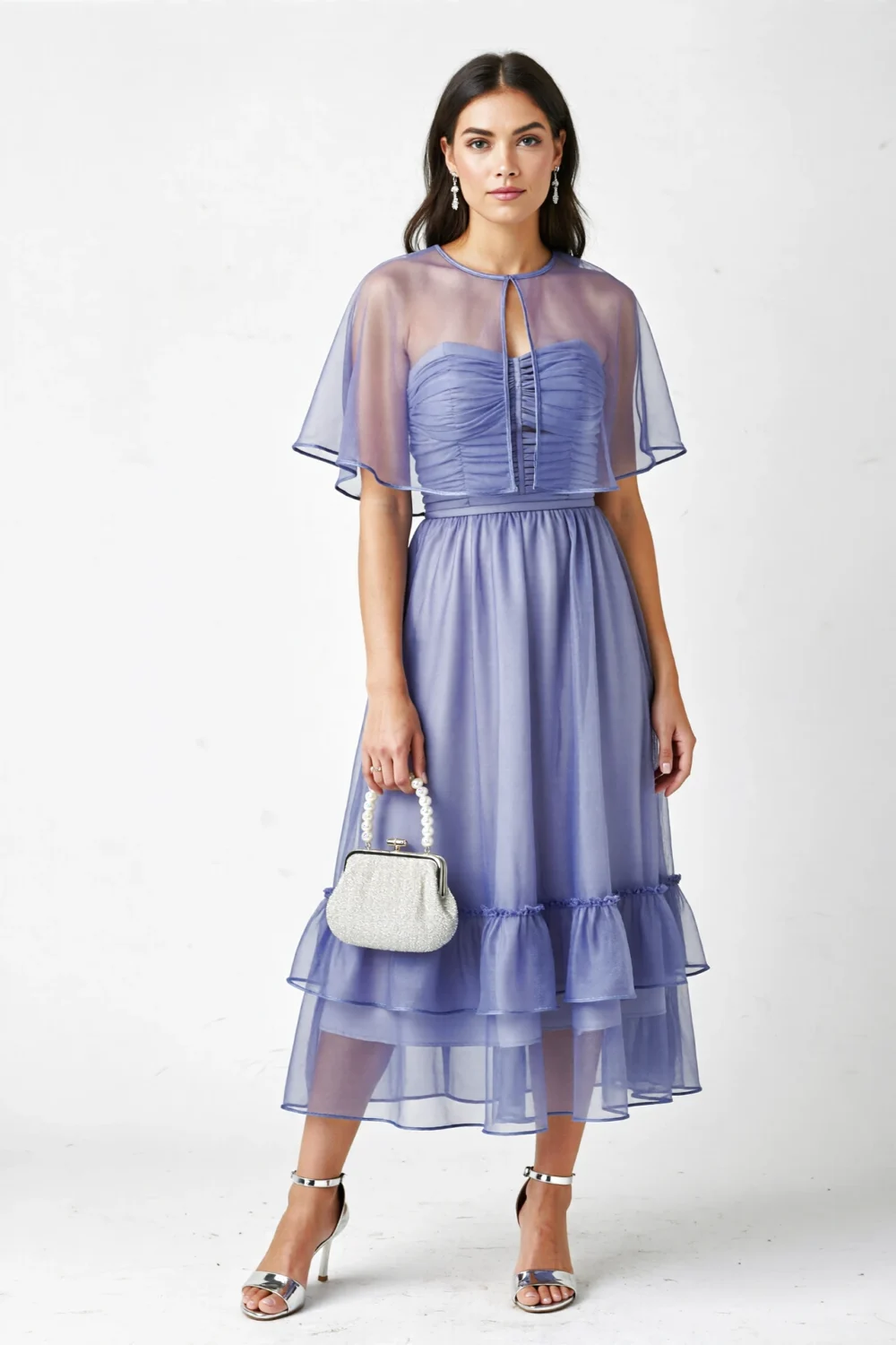 Misty periwinkle strapless chiffon gown with sheer capelet, ruched bodice, tiered tea-length skirt, and silver accessories
