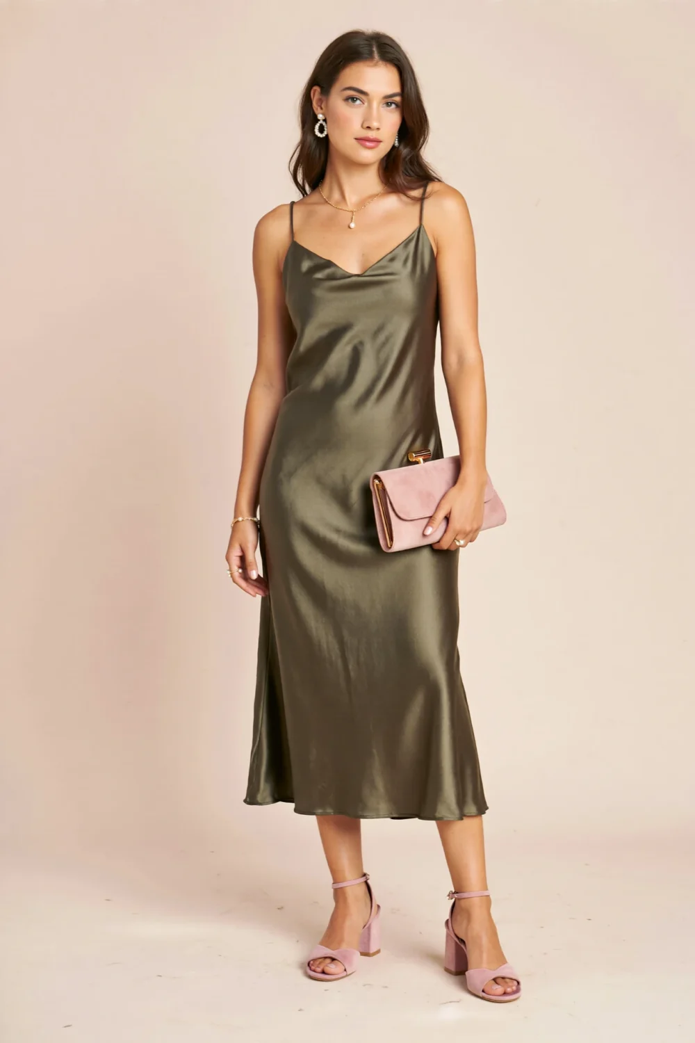 Olive green satin midi dress paired with blush pink heeled sandals and matching clutch for a dreamy, wedding-ready contrast