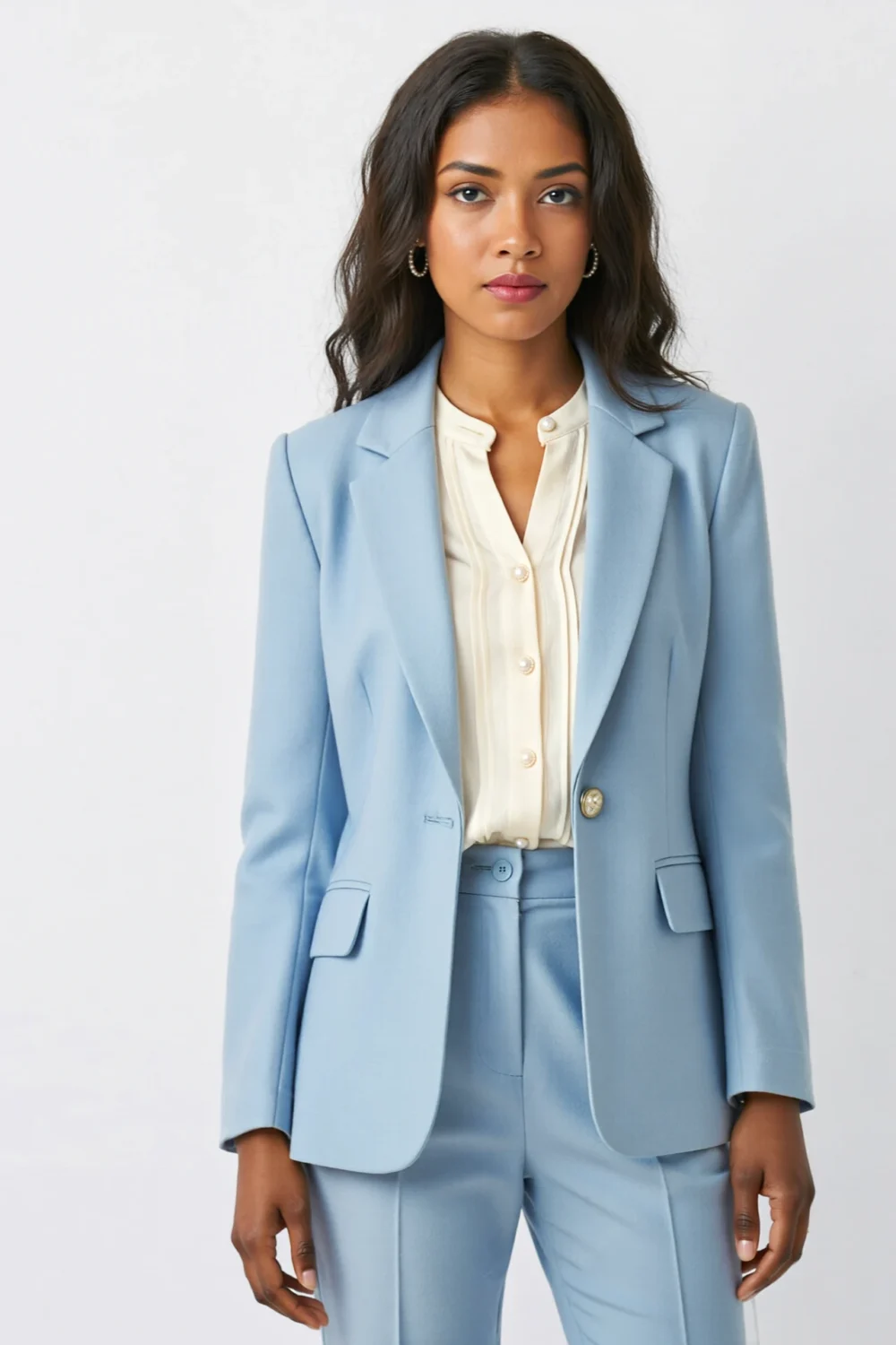 Powder blue suit with ivory pintuck blouse, softly tailored jacket and tapered trousers for an elegant, timeless occasion-ready look