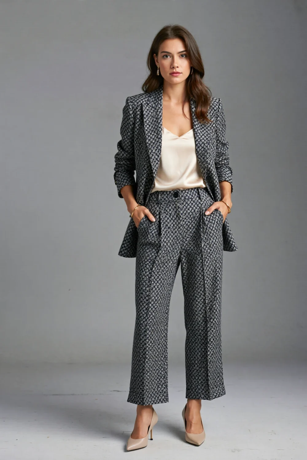 Woman in straight-leg tailored printed trousers and matching blazer, styled with heels for a polished micro-floral daytime-to-evening look