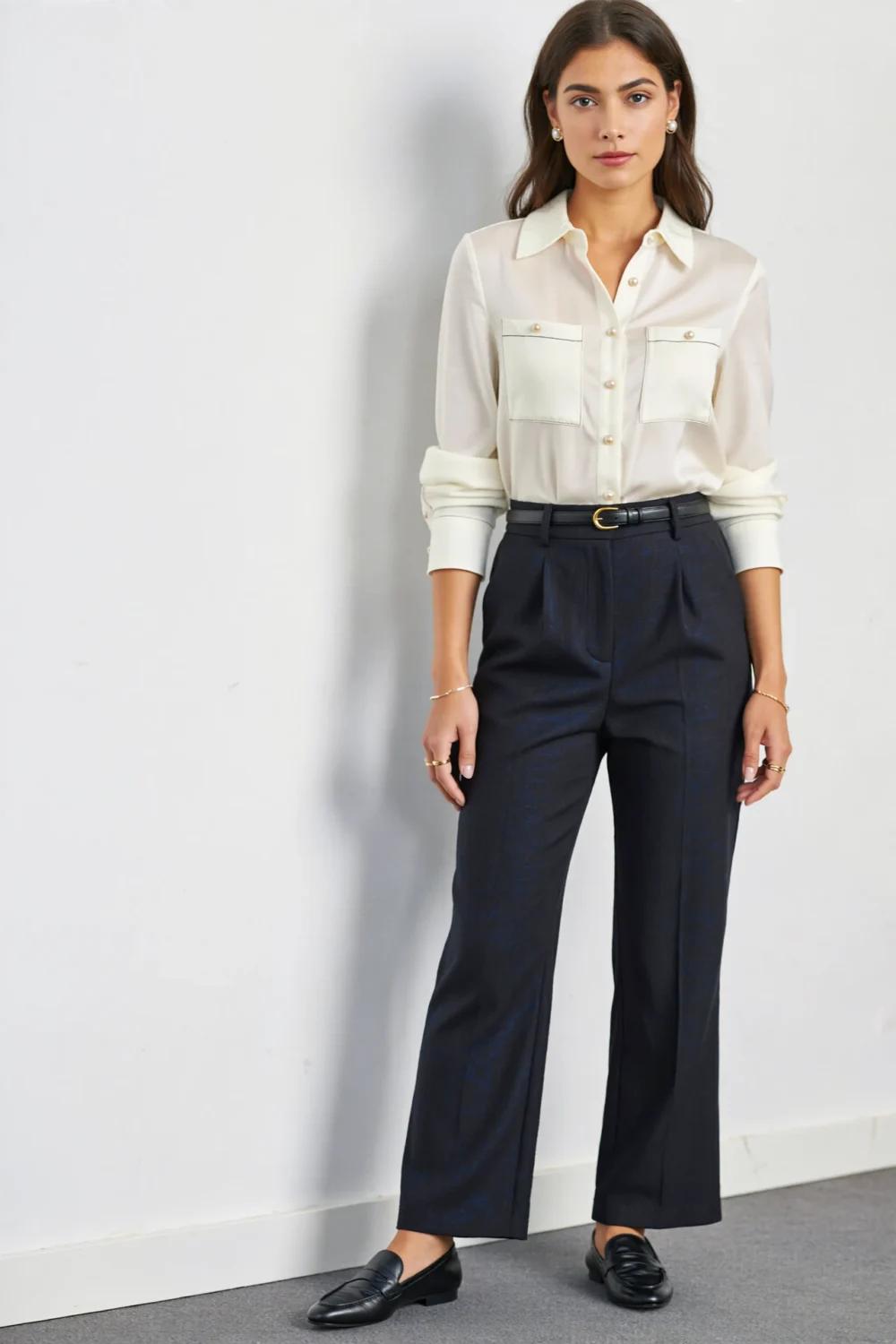 Cream shirt dress styled with tailored navy straight-leg trousers, slim belt, and loafers for a polished office-ready layered look