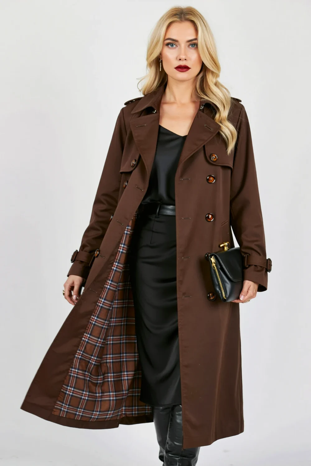Deep espresso trench coat over an all-black outfit, creating a moody chic Halloween party look with dramatic polished style