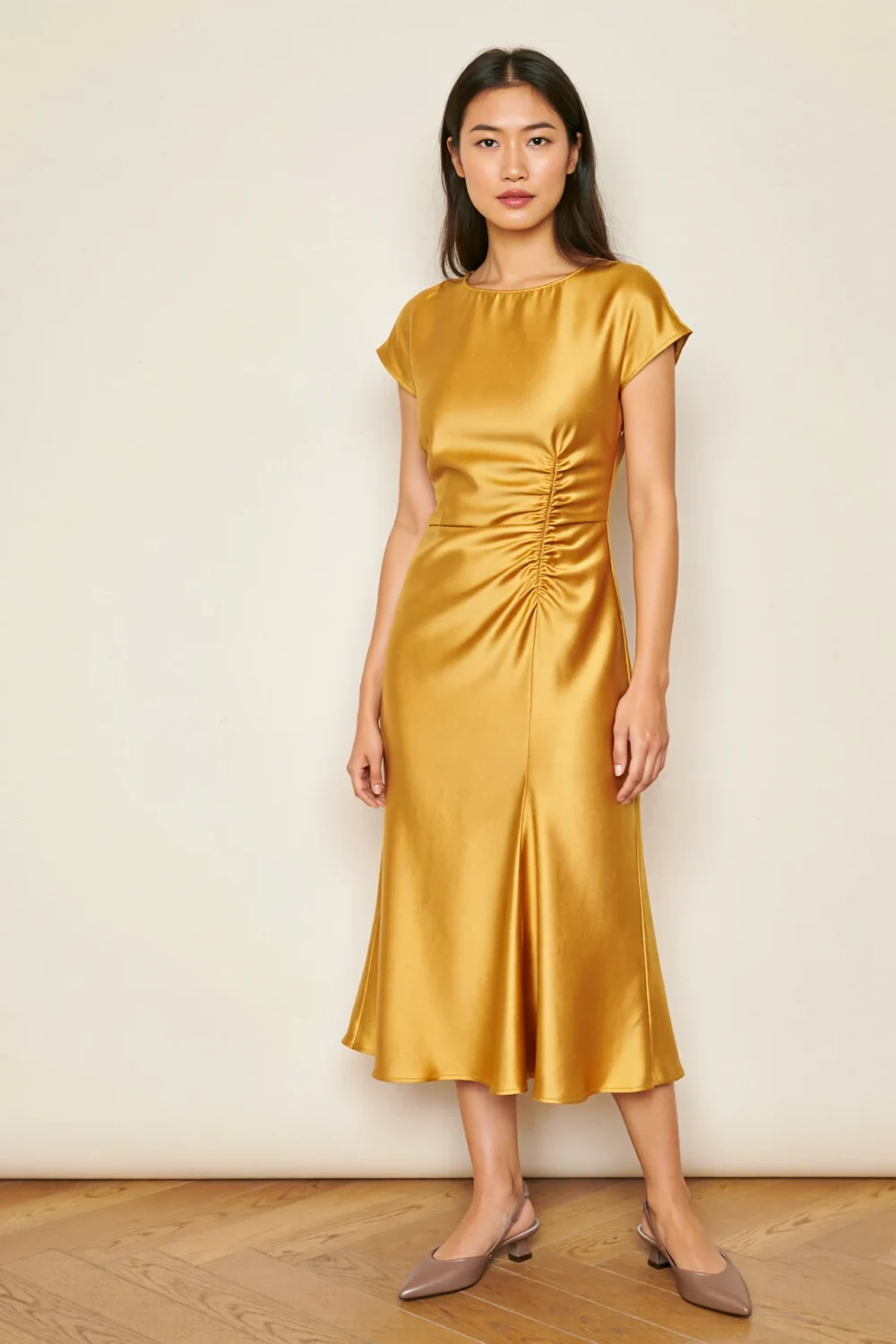 True gold satin midi dress with bateau neckline and taupe pointed pumps, creating a polished, balanced dressy daytime look