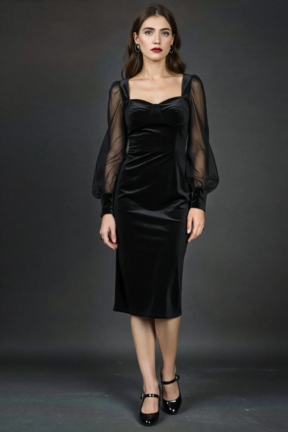 Black velvet midi dress with square neckline and sheer long sleeves, styled with a soft gothic look and elegant fitted silhouette
