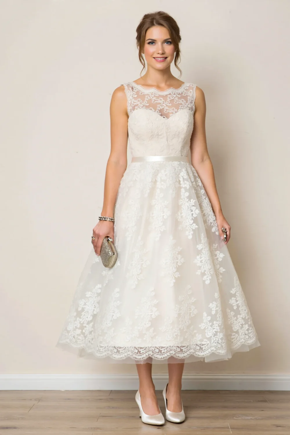 Woman in a white lace dress with white satin pumps, holding a silver clutch, creating a classic bridal-tone formal look